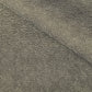 a sheet of Japanese chiyogami paper with a brown background and a small pattern of tiny cream dots in repeat arches