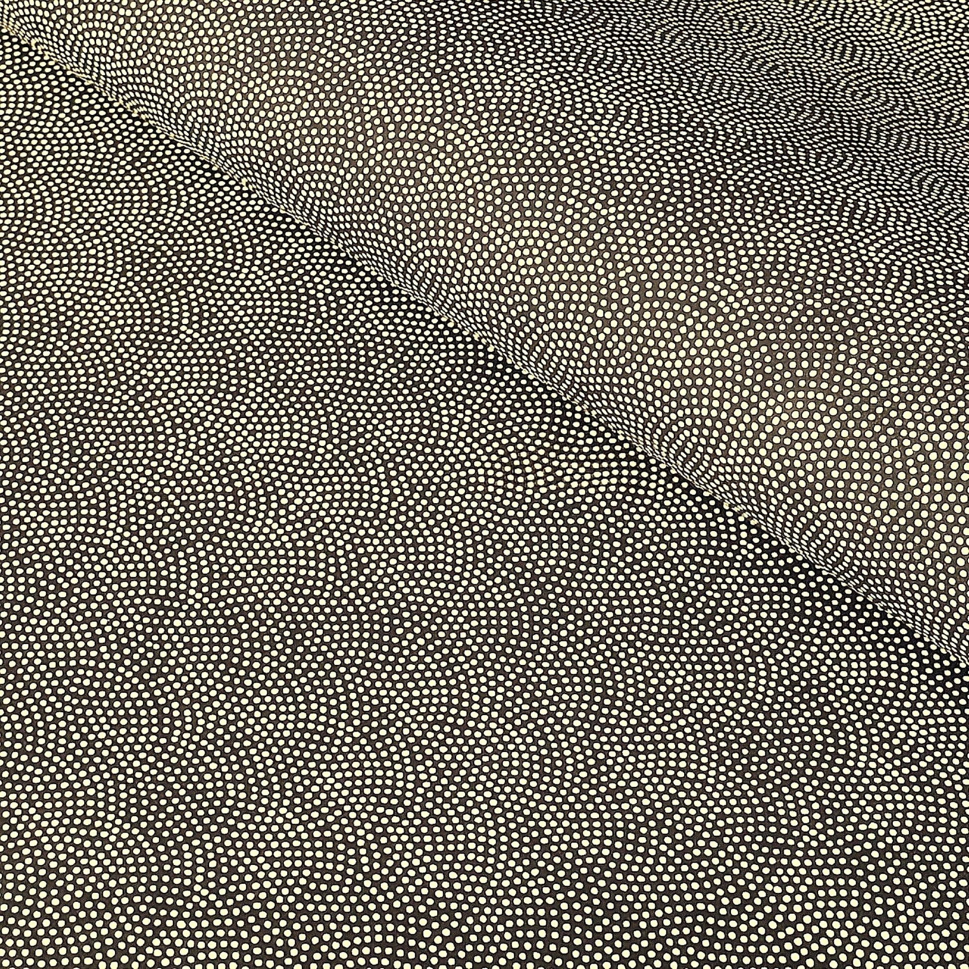 a sheet of Japanese chiyogami paper with a brown background and a small pattern of tiny cream dots in repeat arches