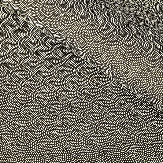 a sheet of Japanese chiyogami paper with a brown background and a small pattern of tiny cream dots in repeat arches