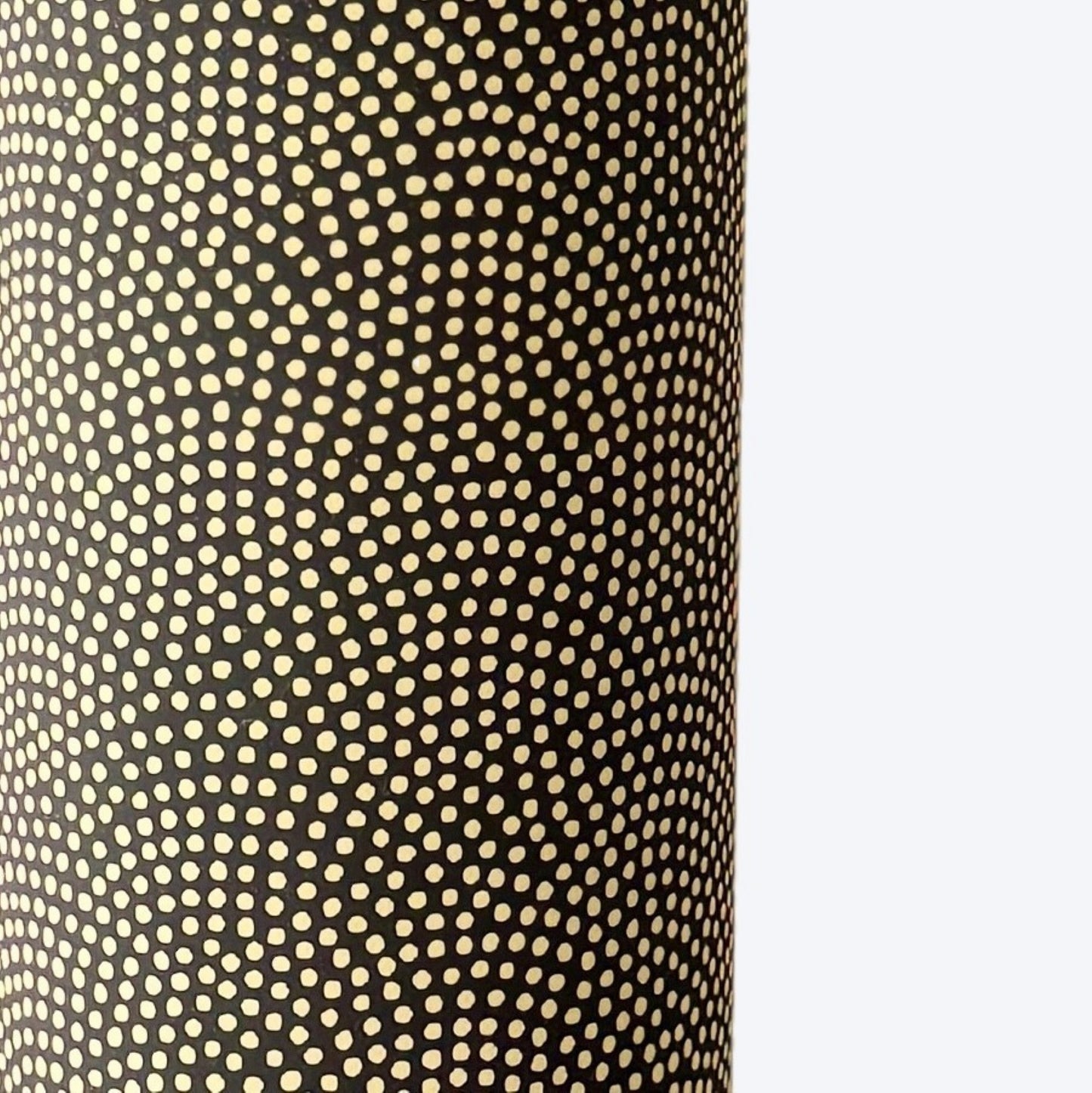 a sheet of Japanese chiyogami paper with a brown background and a small pattern of tiny cream dots in repeat arches