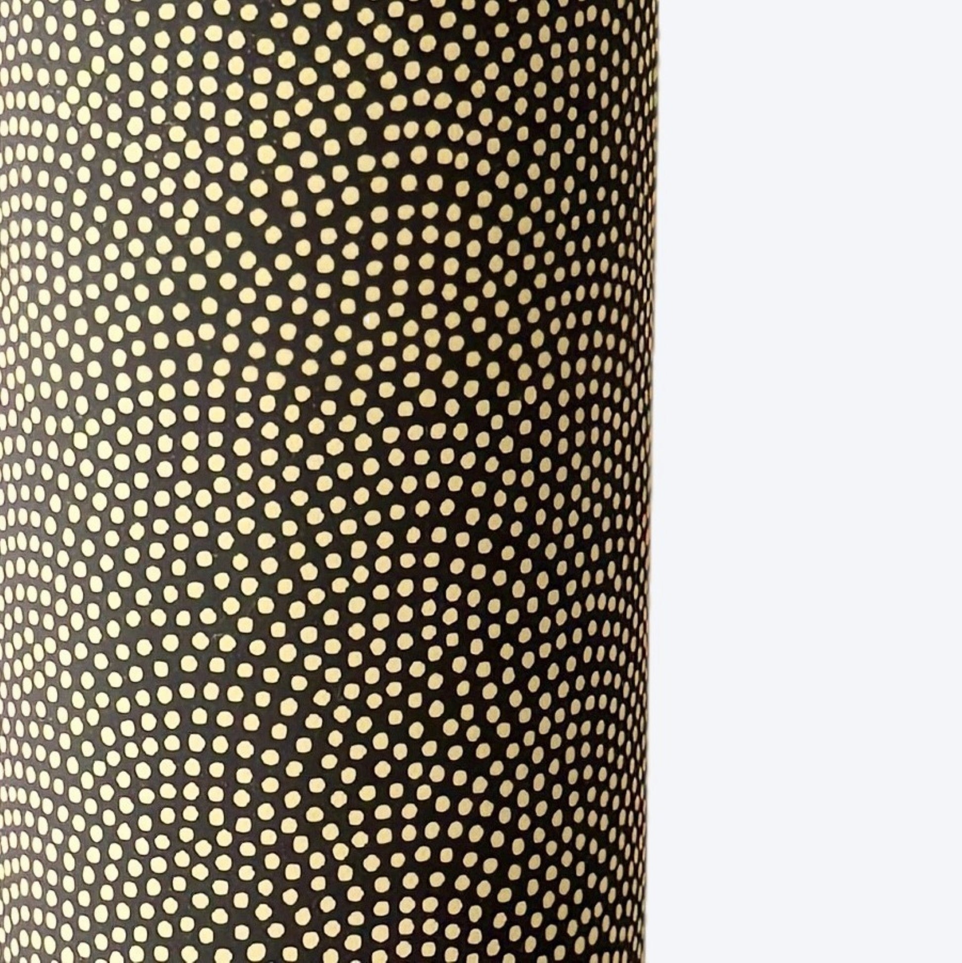 a sheet of Japanese chiyogami paper with a brown background and a small pattern of tiny cream dots in repeat arches