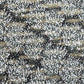 a sheet of chiyogami paper with a dainty spread of little white flowers with gold on a black ground