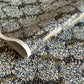 a sheet of chiyogami paper with a dainty spread of little white flowers with gold on a black ground
