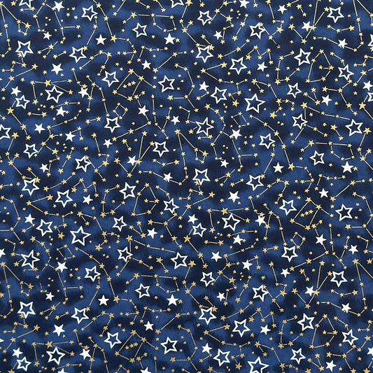 a sheet of Japanese chiyogami yuzen paper with a pattern of white and gold stars on a midnight blue background