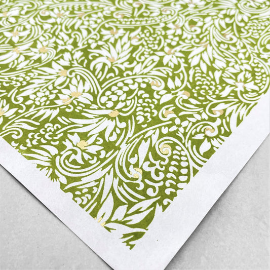 japanese silk-screen handmade paper showing green and white botanical repeat pattern with gold highlights