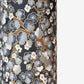a sheet of chiyogami paper with a pattern of plum blossom on branches in indigo, grey, brown and gold