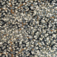 a sheet of chiyogami paper with a pattern of plum blossom on branches in indigo, grey, brown and gold