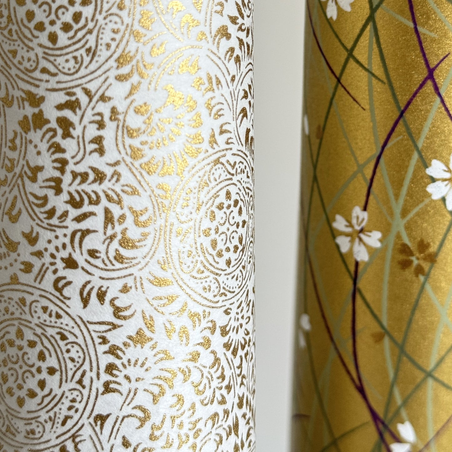 Japanese silkscreen chiyogami paper with an intricate floral pattern in gold on ivory white. Close-up