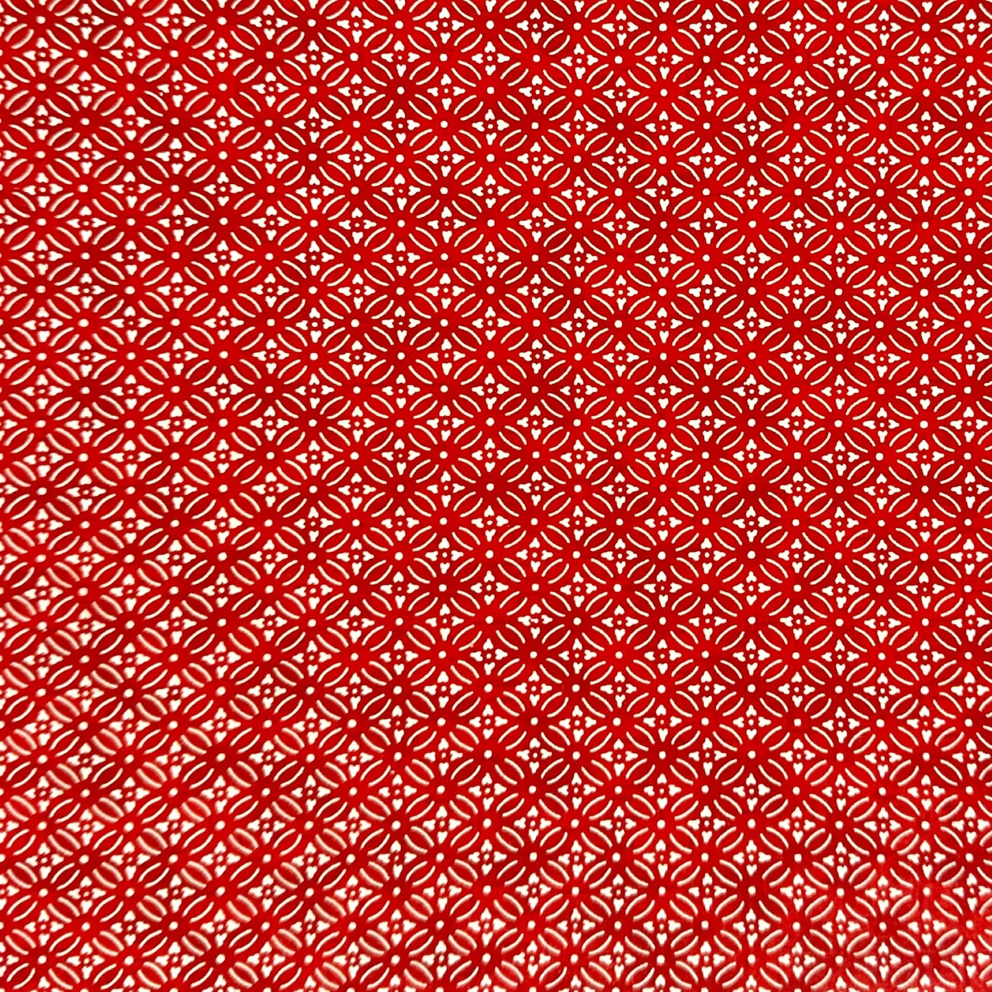 Japanese silkscreen chiyogami paper with a two-tone rich red geometric pattern on creamy white