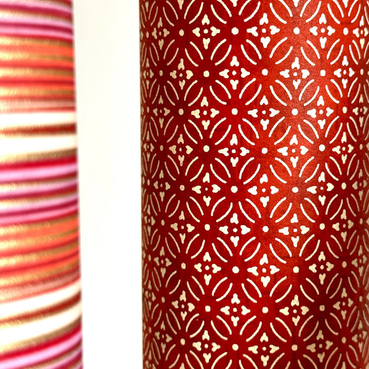 Japanese silkscreen chiyogami paper with a two-tone rich red geometric pattern on creamy white. Close-up