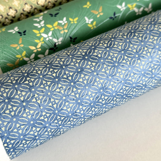 Japanese silkscreen chiyogami paper with a two-tone sky blue geometric pattern on creamy white. Close-up