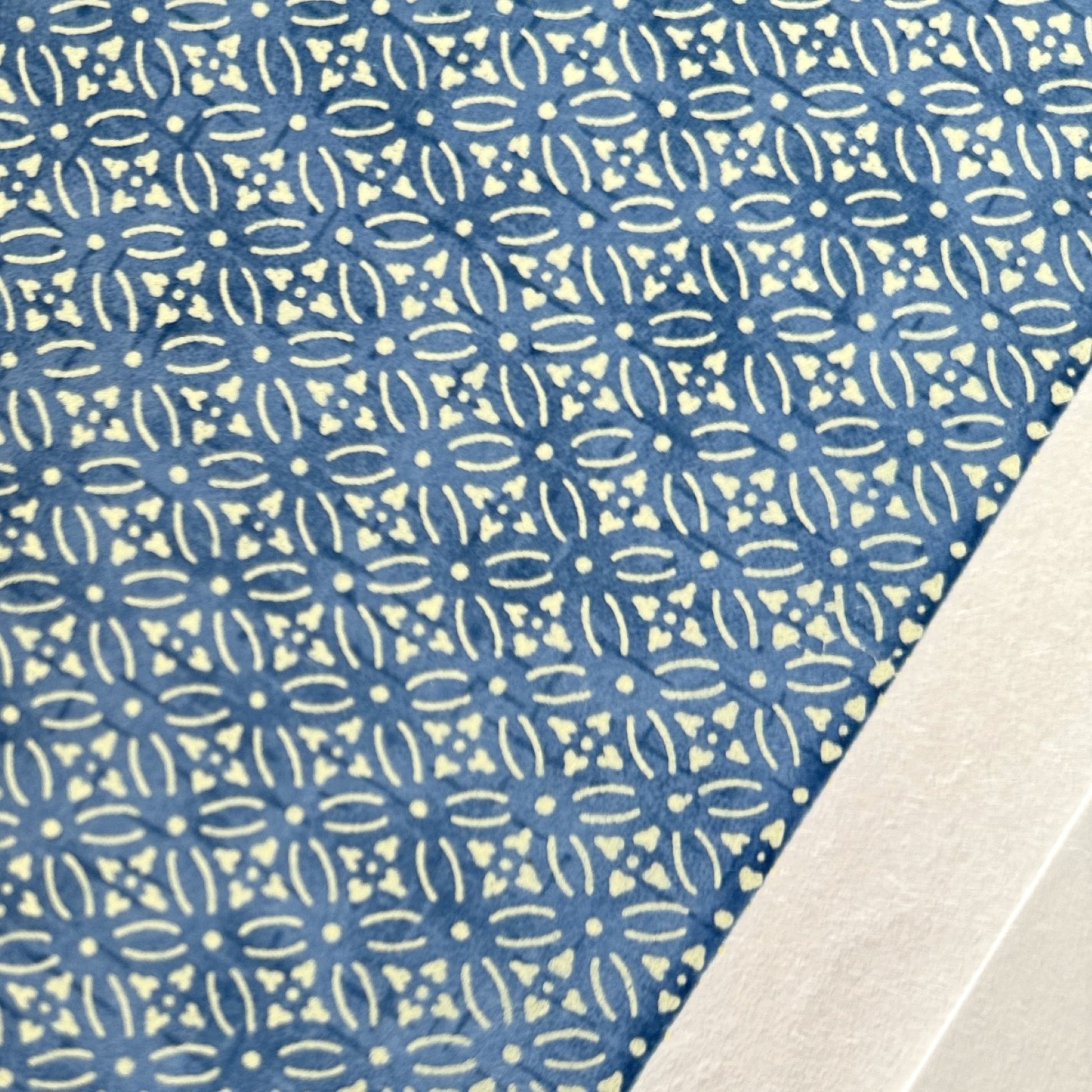 Japanese silkscreen chiyogami paper with a two-tone sky blue geometric pattern on creamy white