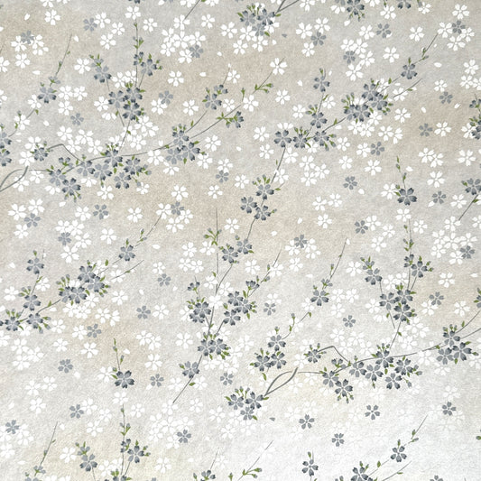Japanese silkscreen chiyogami paper with a delicate flower design in soft grey on an ivory pearlescent backdrop