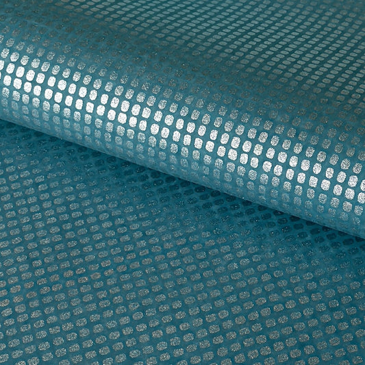 a sheet of Japanese chiyogami paper with a teal background and a repeat pattern of silver rounded rectangles