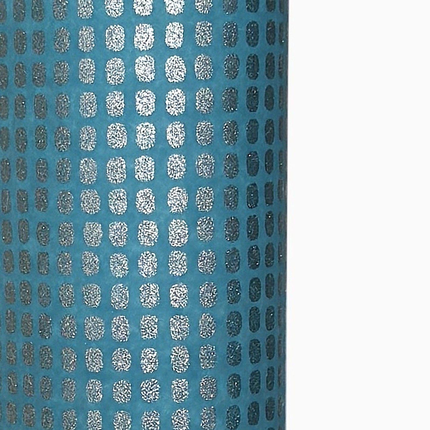 a sheet of Japanese chiyogami paper with a teal background and a repeat pattern of silver rounded rectangles