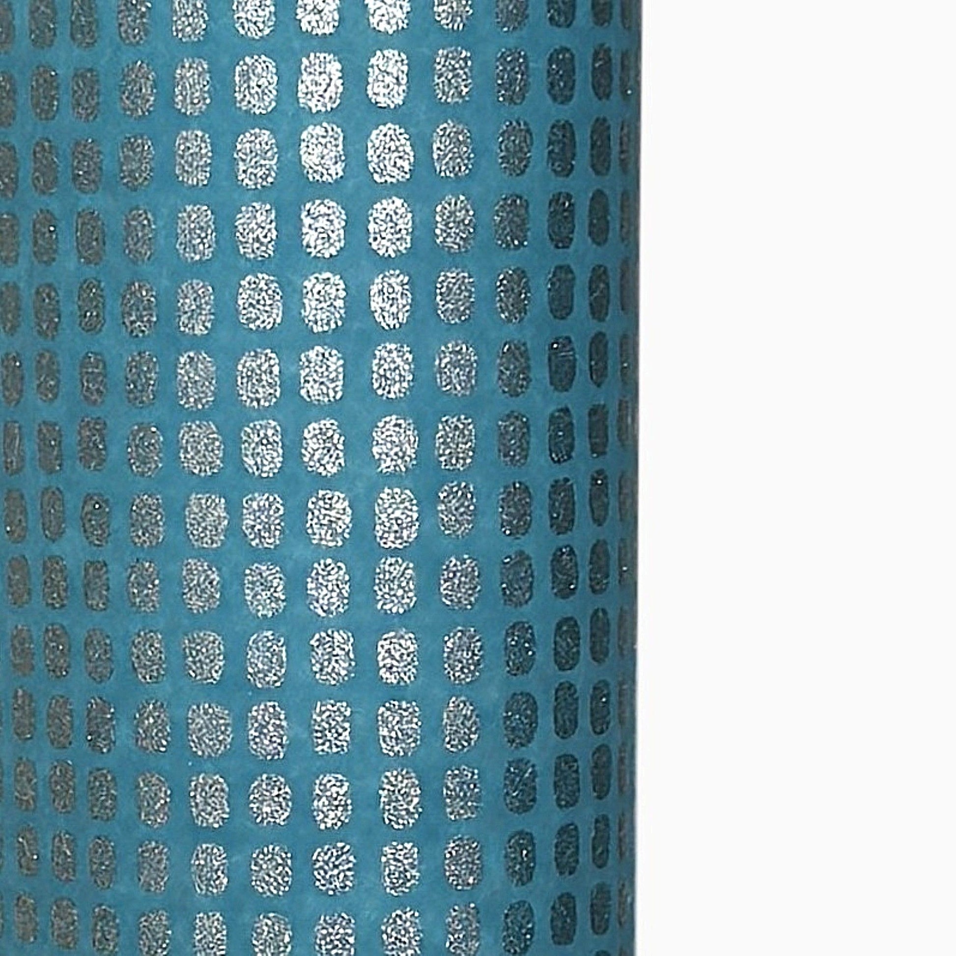 a sheet of Japanese chiyogami paper with a teal background and a repeat pattern of silver rounded rectangles
