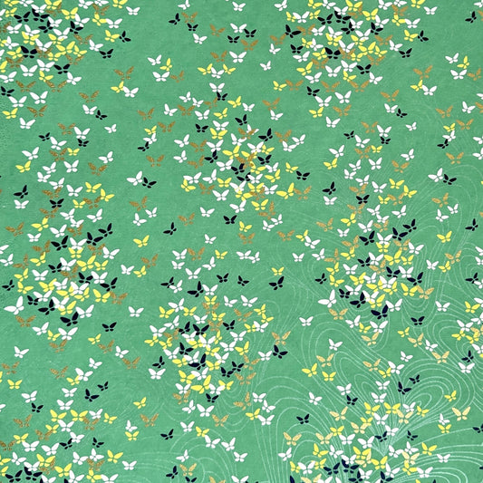 Japanese silkscreen chiyogami paper with a delicate butterfly pattern on a teal backdrop
