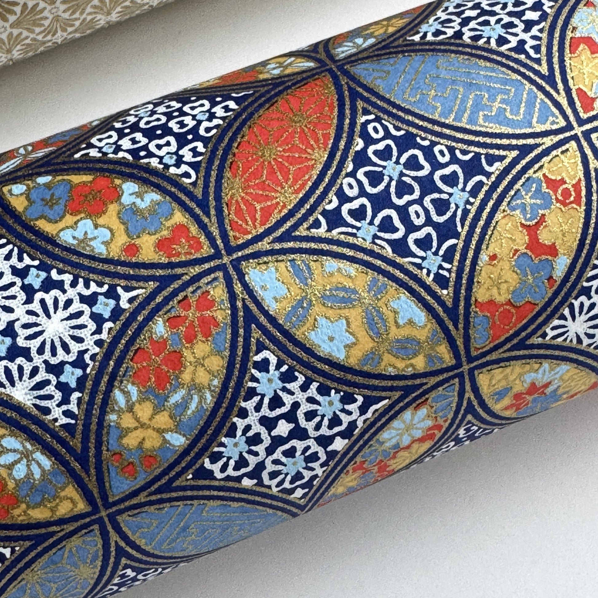 a sheet of Japanese silkscreen printed chiyogami yuzen paper with a design of overlapping circles in blue, red, yellow and white