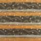 japanese chiyogami paper in stripes of black, brown, ochre and grey with gold clouds and flowers
