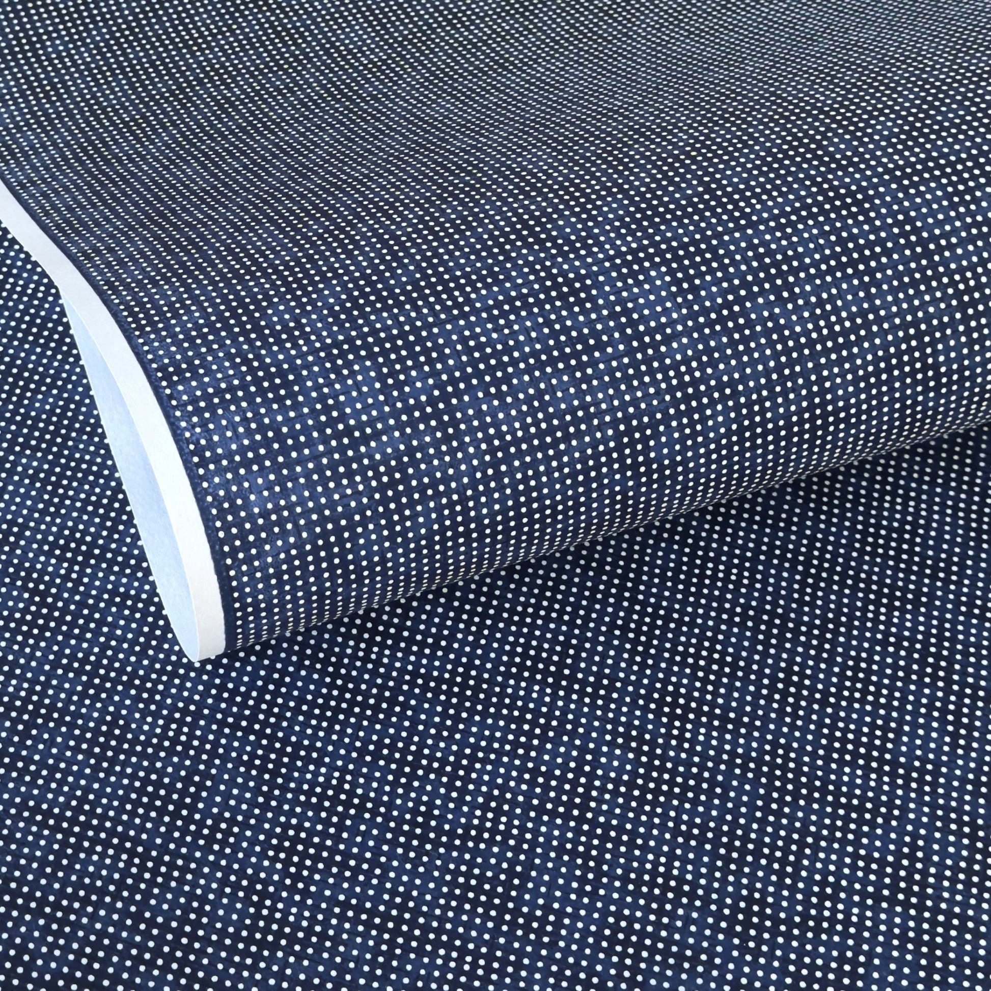 a sheet of indigo Japanese chiyogami paper with tiny white polka dots
