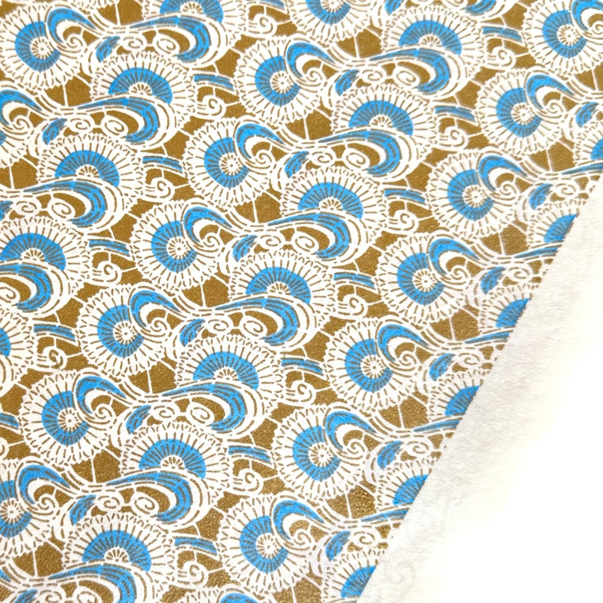 Japanese silkscreen chiyogami paper with a repeat floral pattern in gold an cerulean blue