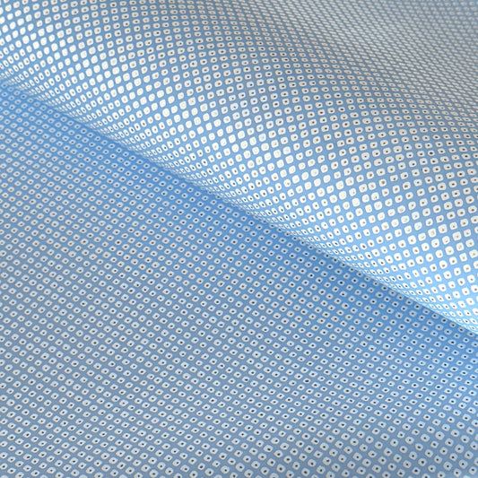 a sheet of chiyogami paper with a sky blue background and little irregular white dots with a silver centre