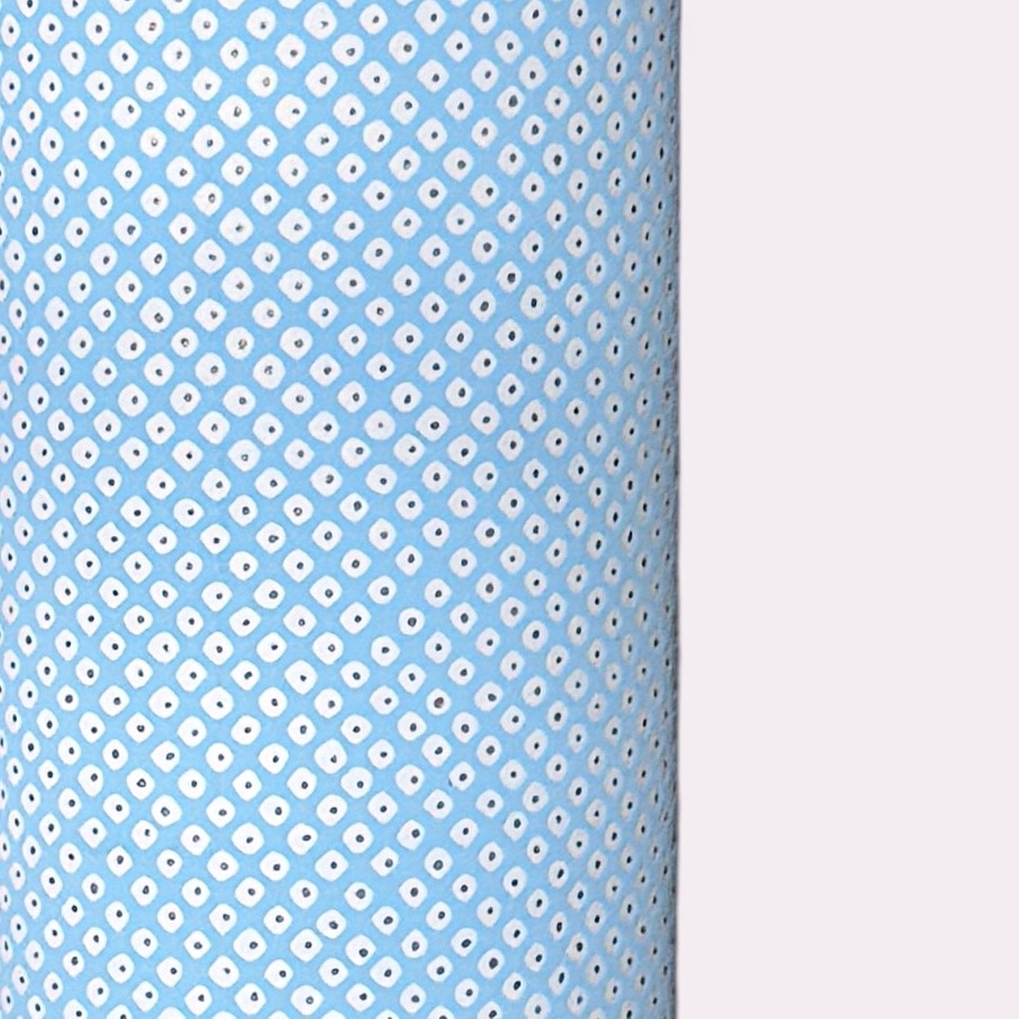 a sheet of chiyogami paper with a sky blue background and little irregular white dots with a silver centre