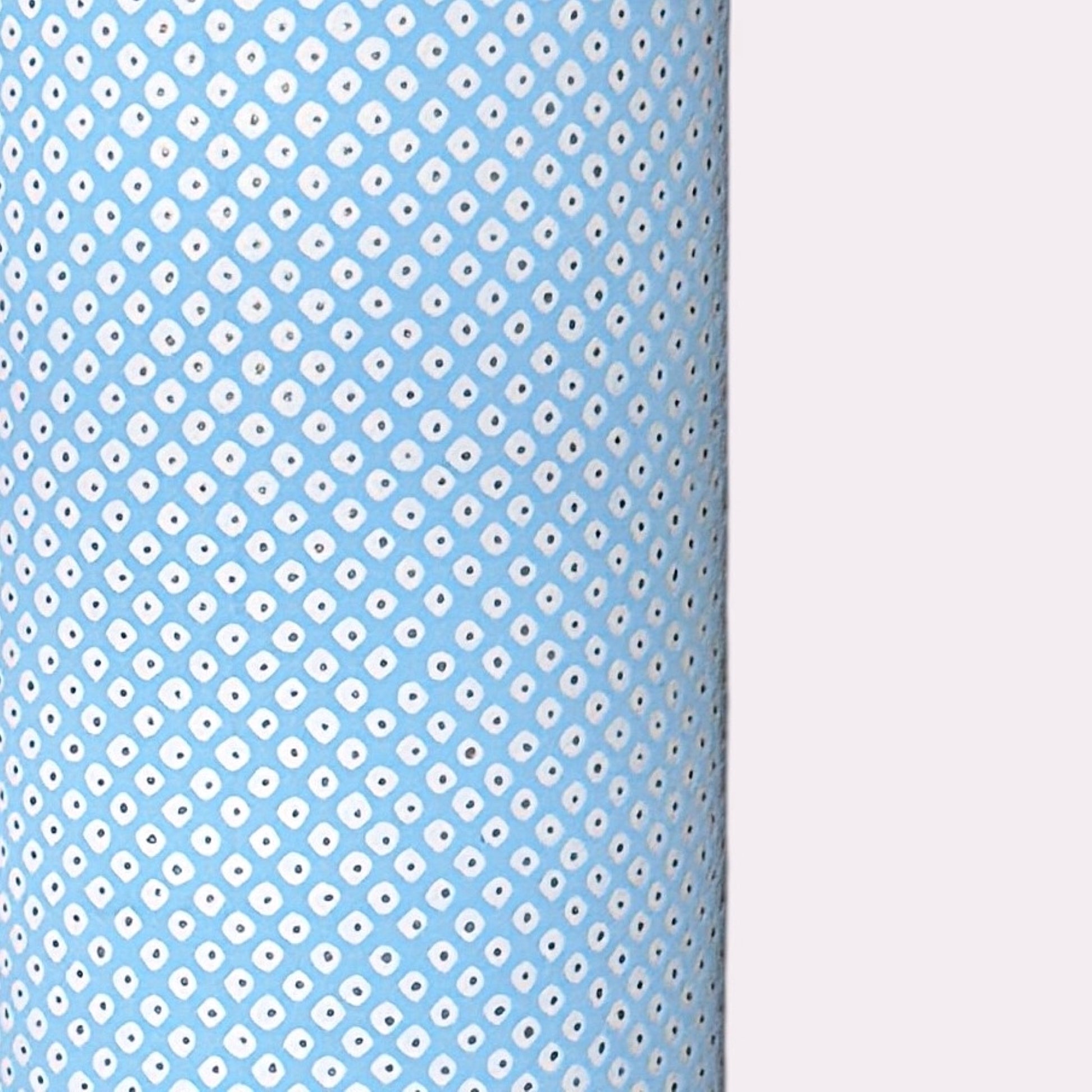 a sheet of chiyogami paper with a sky blue background and little irregular white dots with a silver centre