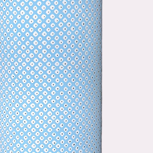 a sheet of chiyogami paper with a sky blue background and little irregular white dots with a silver centre