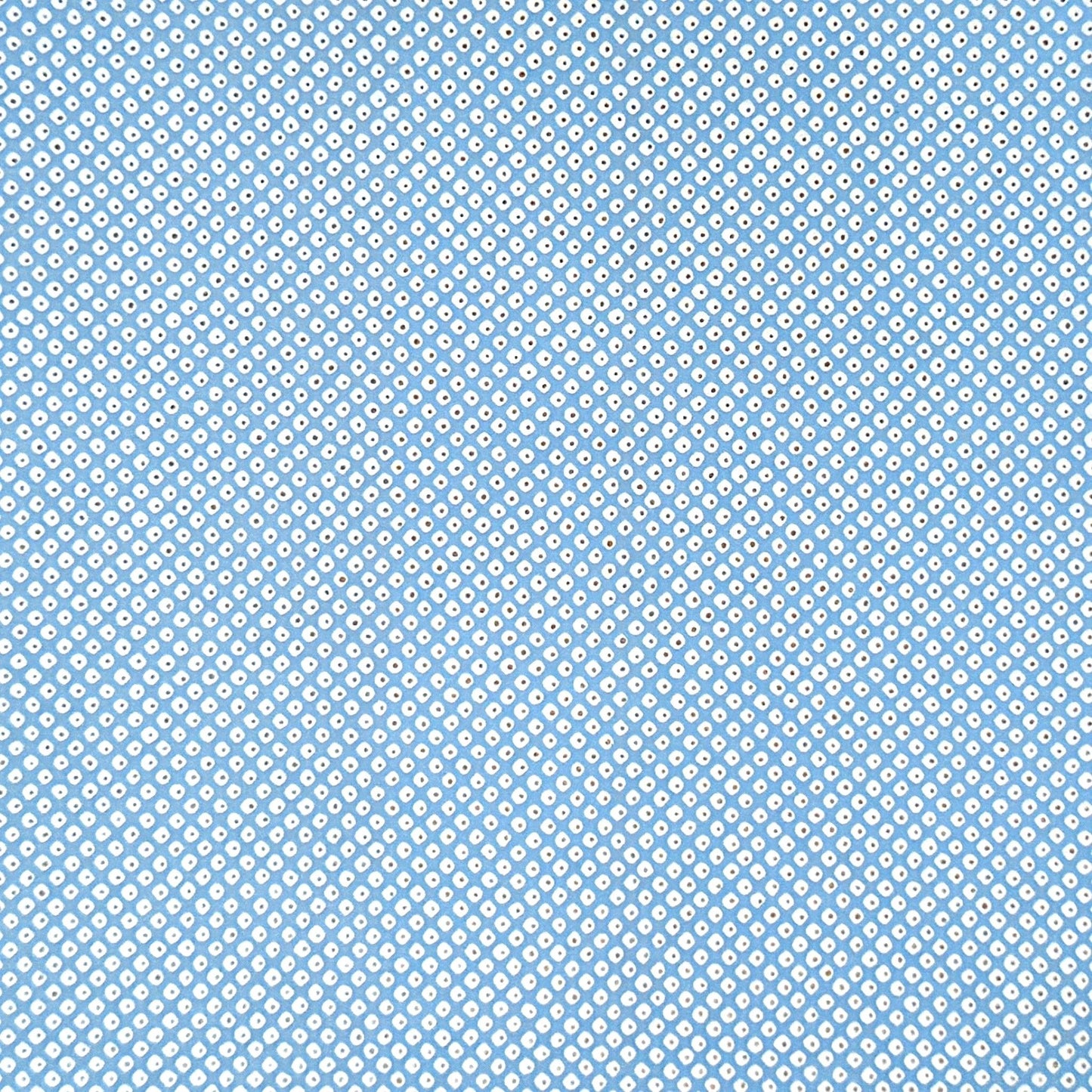 a sheet of chiyogami paper with a sky blue background and little irregular white dots with a silver centre