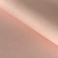 a sheet of Japanese chiyogami paper with a blush pink background and a small pattern of white dots in repeating arch shape