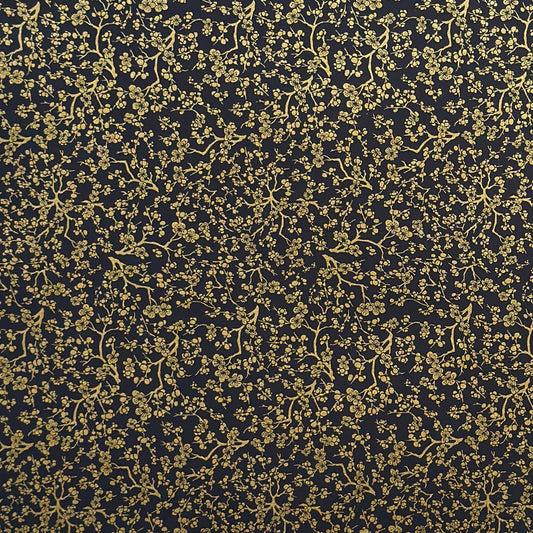 a sheet of Japanese chiyogami yuzen paper with a micro botanical pattern in gold on black