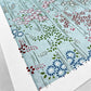 japanese silk-screen handmade paper showing pattern of bamboo, flowers and foliage on light teal backdrop