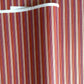 Japanese silkscreen chiyogami paper with a classic narrow stripe pattern in berry tones of red, pink, purple and gold.