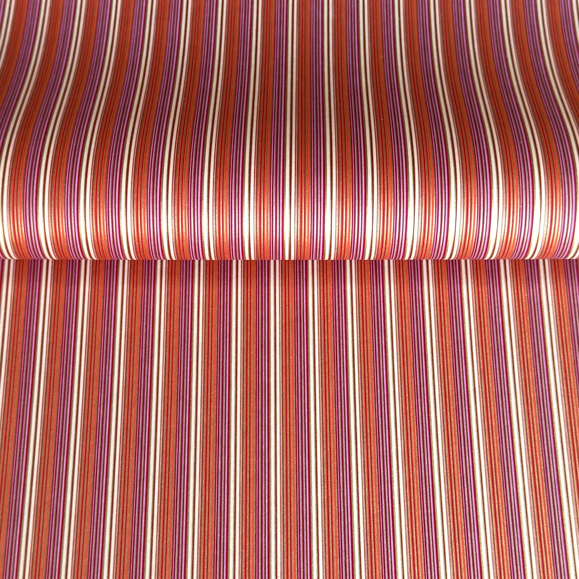 Japanese silkscreen chiyogami paper with a classic narrow stripe pattern in berry tones of red, pink, purple and gold.