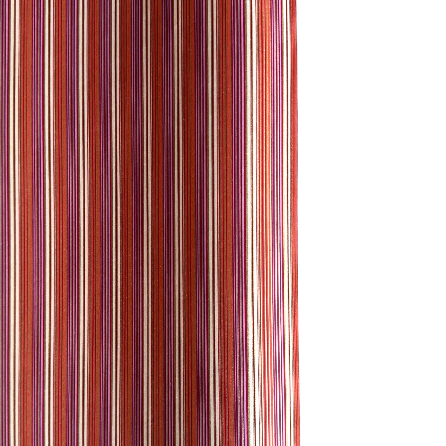 Japanese silkscreen chiyogami paper with a classic narrow stripe pattern in berry tones of red, pink, purple and gold.