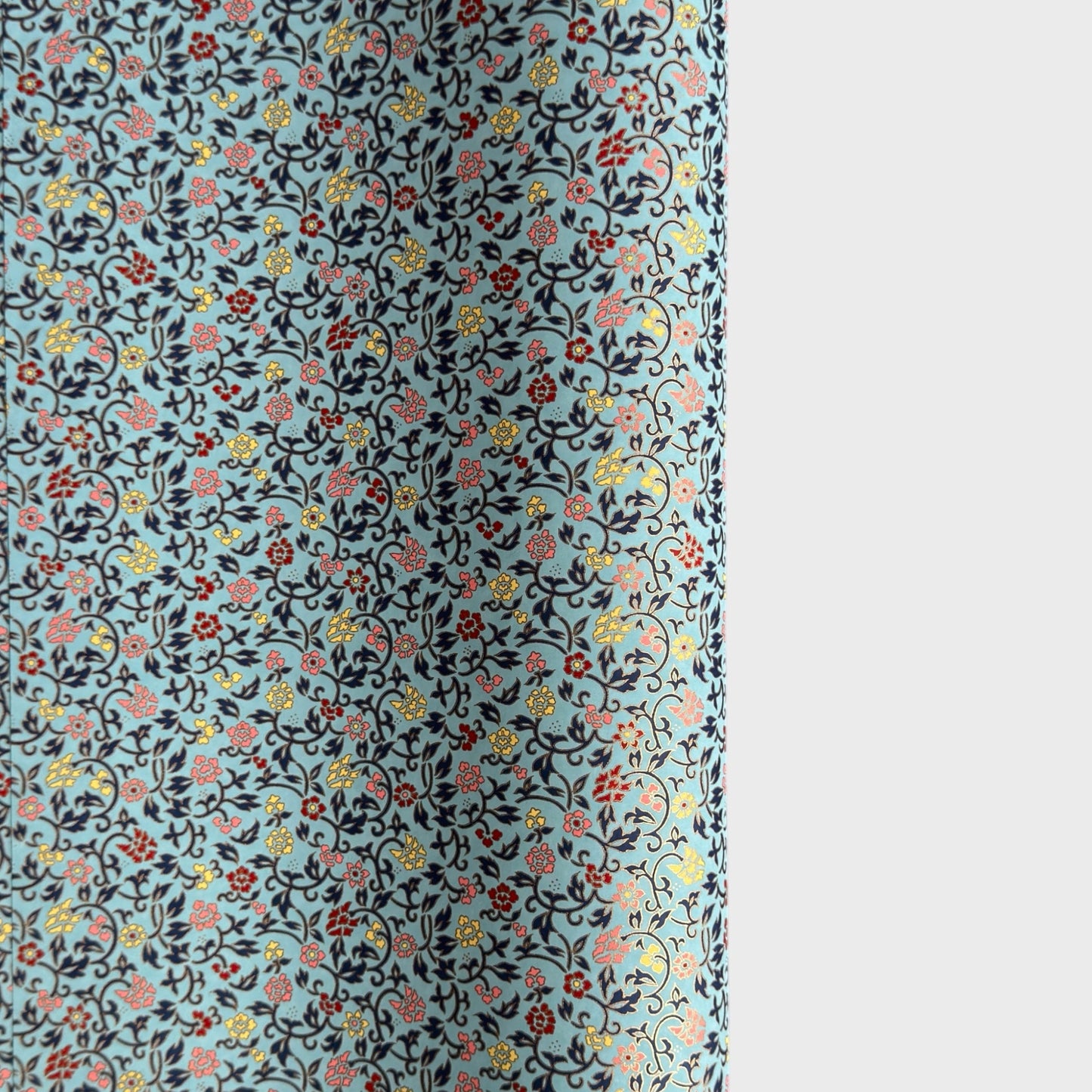 Japanese silkscreen chiyogami paper with a dainty floral pattern in navy, yellow and coral on a teal backdrop. Finished with gold metallic ink.