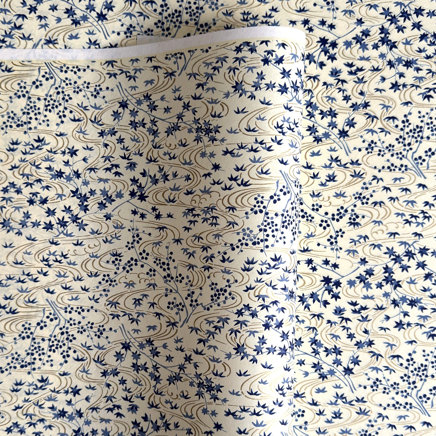 japanese silk-screen handmade paper showing gold rivers and blue falling leaves and foliage