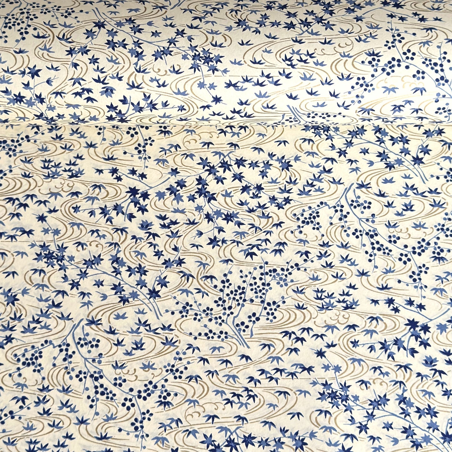 japanese silk-screen handmade paper showing gold rivers and blue falling leaves and foliage
