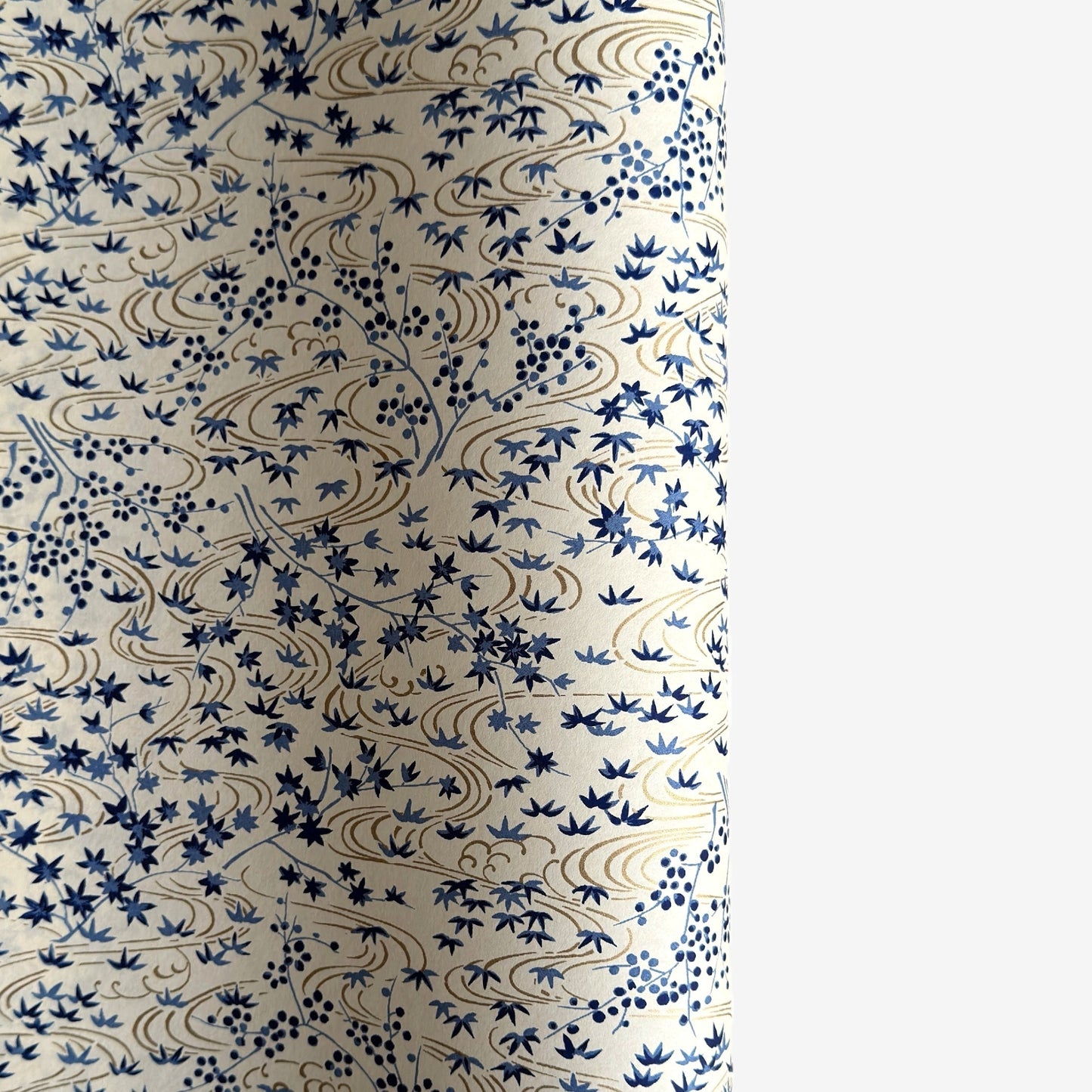 japanese silk-screen handmade paper showing gold rivers and blue falling leaves and foliage