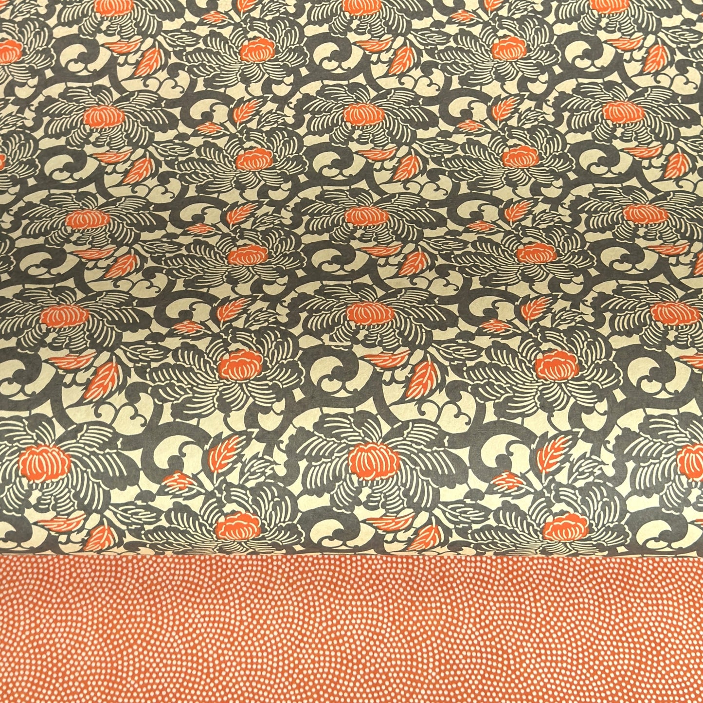 japanese silk-screen handmade paper showing grey and orange peony flower repeat pattern