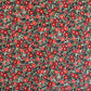 japanese silk-screen handmade paper, chiyogami, with a design showing red and pink camellia flowers and green leaves on black background