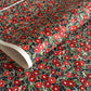 japanese silk-screen handmade paper, chiyogami, with a design showing red and pink camellia flowers and green leaves on black background