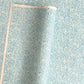 Japanese chiyogami paper - silkscreen printed - light blue backdrop with a small botanical pattern in white with silver accents.