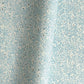 Japanese chiyogami paper - silkscreen printed - light blue backdrop with a small botanical pattern in white with silver accents.