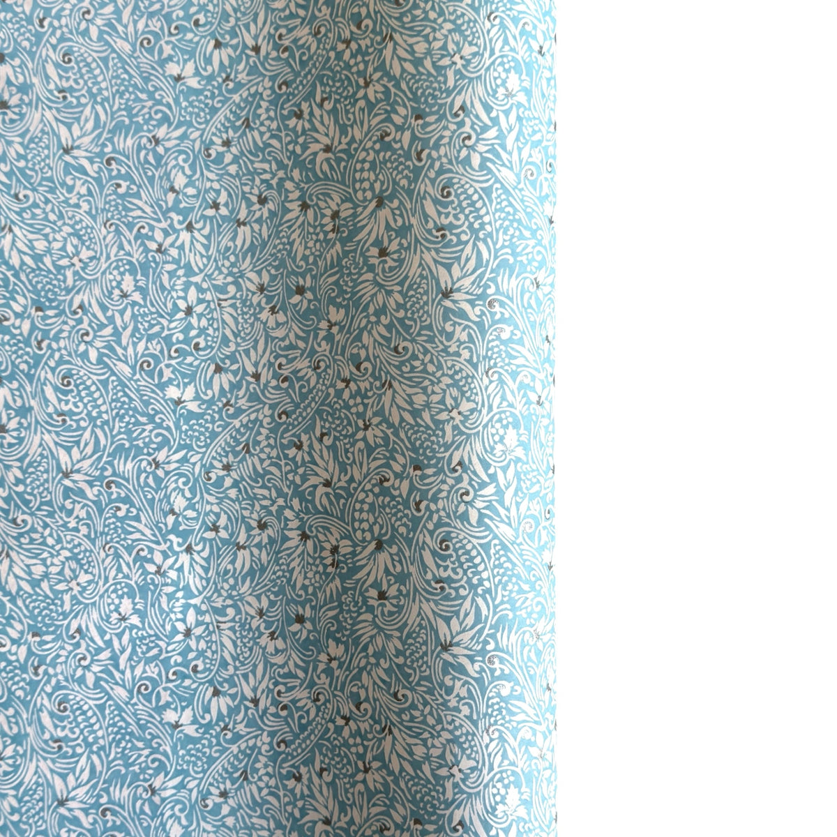 Japanese chiyogami paper - silkscreen printed - light blue backdrop with a small botanical pattern in white with silver accents.