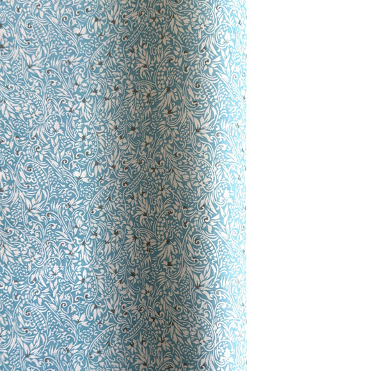 Japanese chiyogami paper - silkscreen printed - light blue backdrop with a small botanical pattern in white with silver accents.