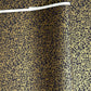 a sheet of Japanese chiyogami yuzen paper with a micro botanical pattern in gold on black