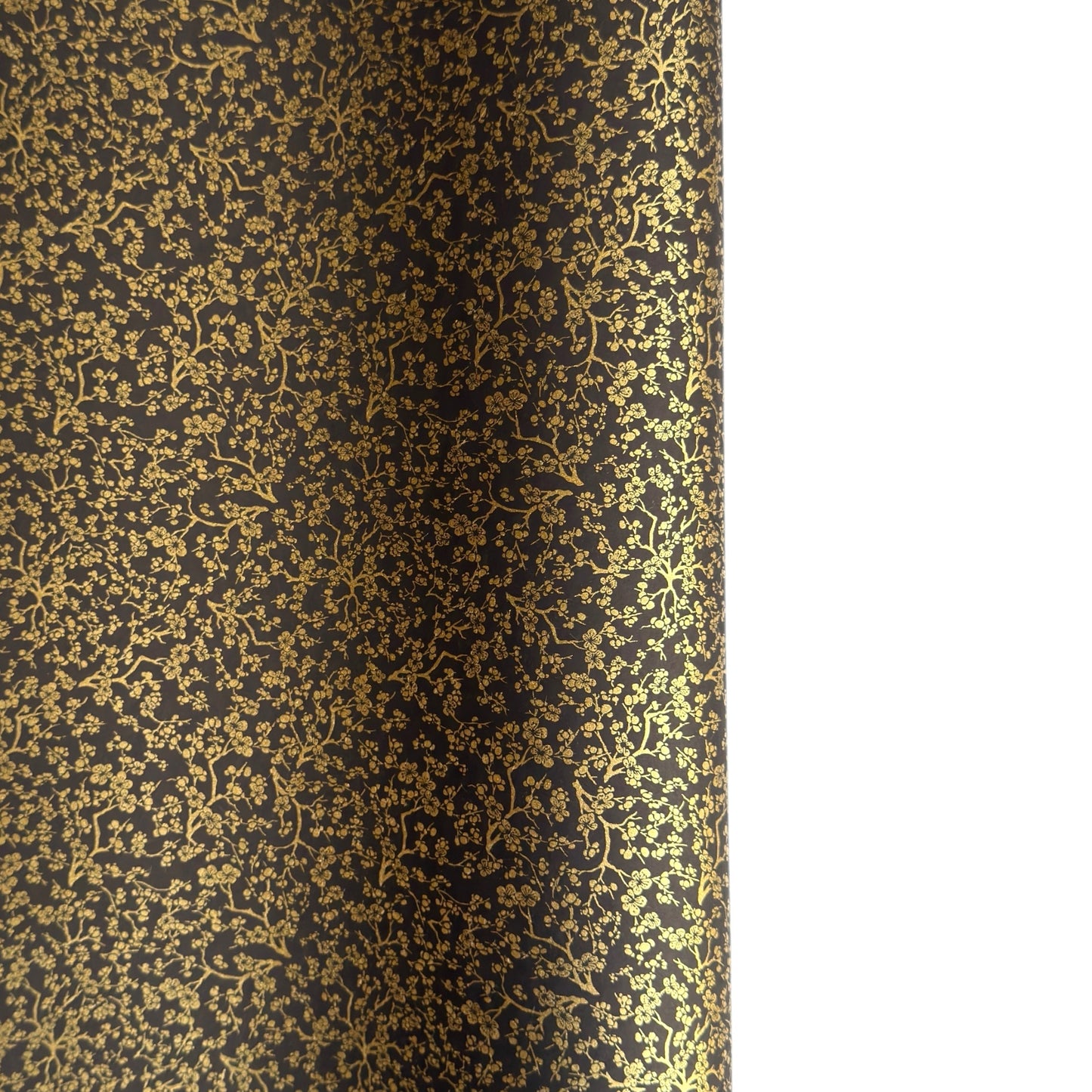 a sheet of Japanese chiyogami yuzen paper with a micro botanical pattern in gold on black