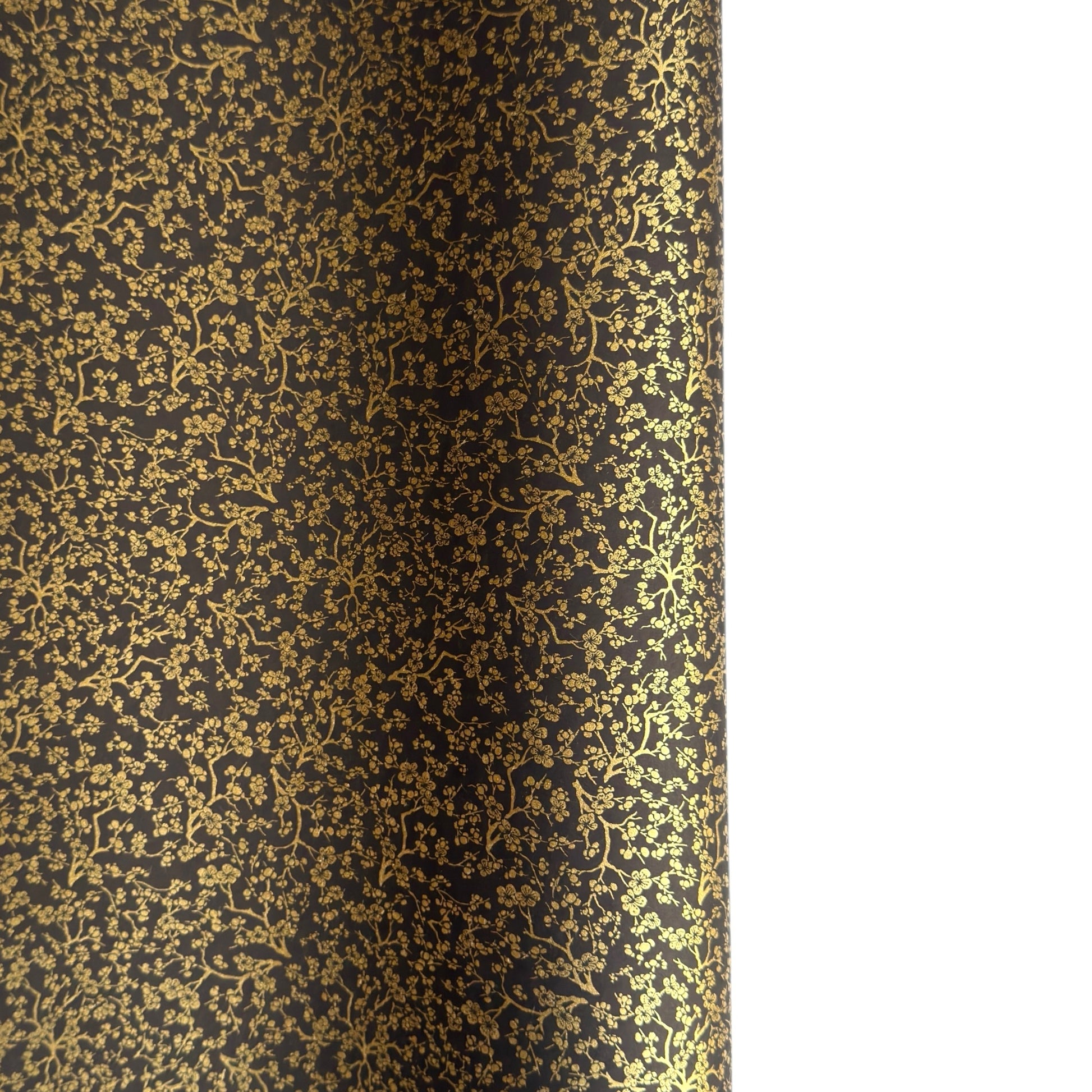 a sheet of Japanese chiyogami yuzen paper with a micro botanical pattern in gold on black